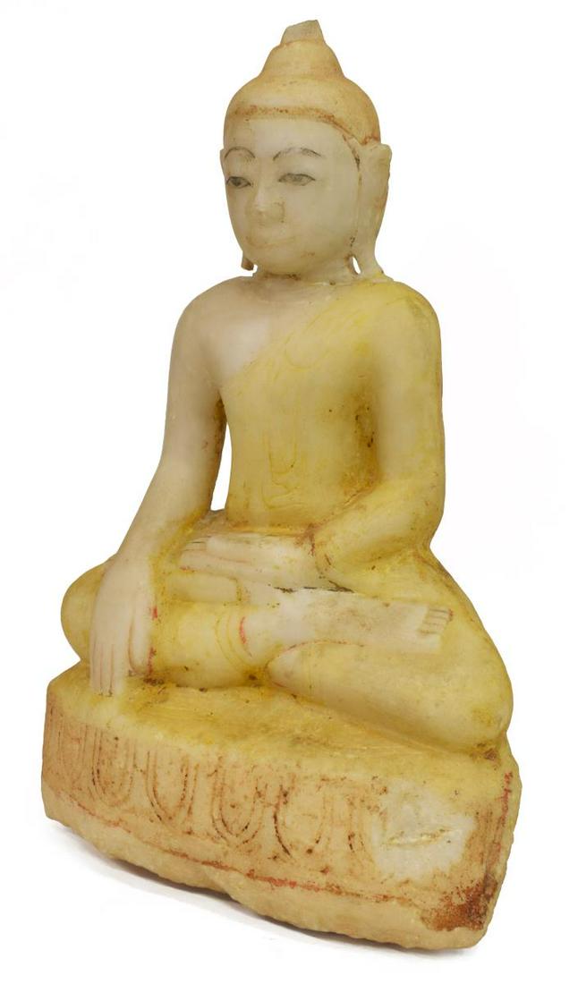 BURMESE CARVED STONE BHUMISPARSHA BUDDHA: Burmese carved stone Buddha, seated in Bhumisparsha (earth-touching) Mudra, elongated earlobes, the tightly curled hair in a top knot, remnants of polychrome pigment, restoration to neck, losses at to