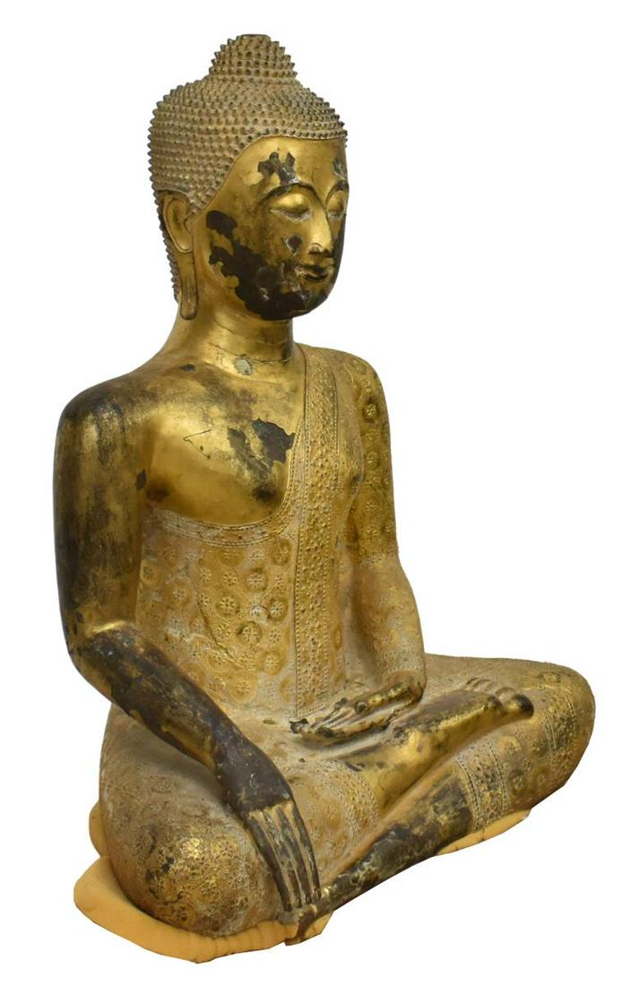 LARGE THAI GILT BRONZE SEATED BUDDHA FIGURE: Large Thai gilt bronze Buddha, seated in Bhumisparsha (earth touching) Mudra, tightly curled hair in a top knot, elaborately patterned robes, lacking element at top of head,loss and break to metal at 