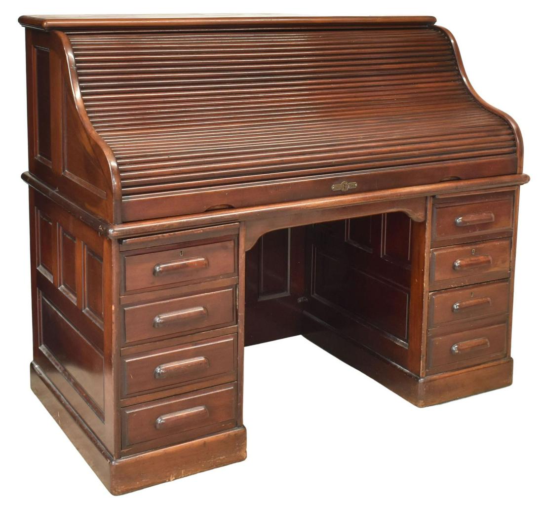 AMERICAN DERBY CO. MAHOGANY ROLL-TOP WRITING DESK: American mahogany roll-top writing desk, Derby Desk Co., Boston, Massachusetts, early 20th c., paneled case, roll top opening to fitted interior storage, two drawers and open shelving, over central kn