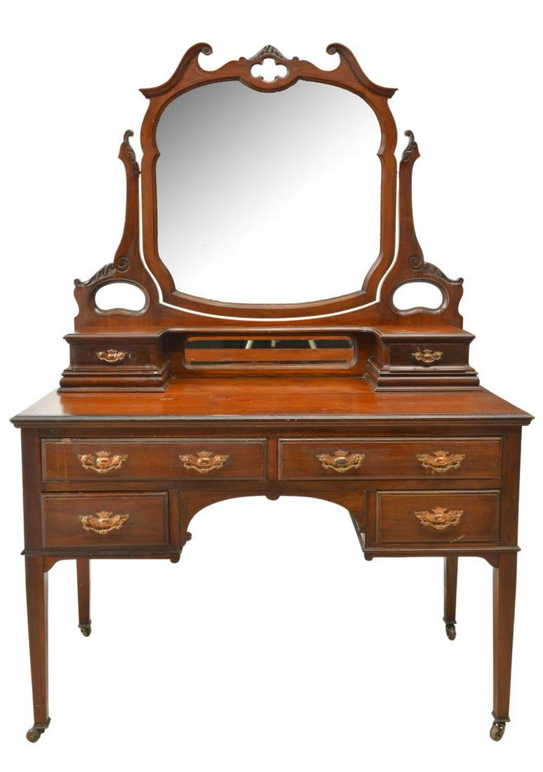 ENGLISH VICTORIAN MAHONGAY VANITY DRESSING TABLE: English Victorian mahogany vanity dressing table, late 19th c., having shaped beveled mirror plate, fixed to adjustable supports, in foliate carved frame, over two drawers, on cabinet fitted with four