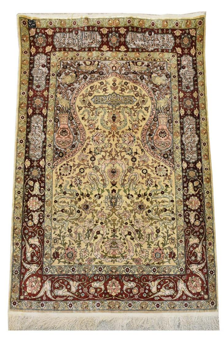 HEREKE STYLE SILK GOLD & SILVER THREAD PRAYER RUG: Chinese Hereke style silk on silk prayer rug, embellished with heavy gold and silver thread, calligraphy, foliage and fauna, approx 4'10.5"l, 3'3.5" (exclusive of fringe) Start Price: $400.00