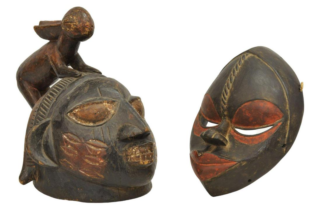 (2) AFRICAN CARVED WOOD MASKS, PUNU & YORUBA: (lot of 2) African carved wood masks, including: (1) Yoruba People, Nigeria, Benin, Togo, part of Ghana, nicely cared with exaggerated facial features, a carved rabbit sits at the top with loss at tai