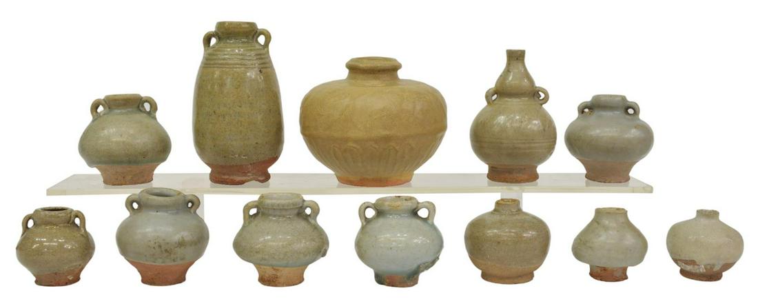 (12) SAWANKHALOK CELADON-GLAZED MINIATURE VESSELS: (lot of 12) Celadon-glazed earthenware ceramics, likely Sawankhalok, Thailand, many miniature jars, highlights include: (1) double gourd vase, with incised bands, approx 4"h, 2.75"diam, (1) tall doubl