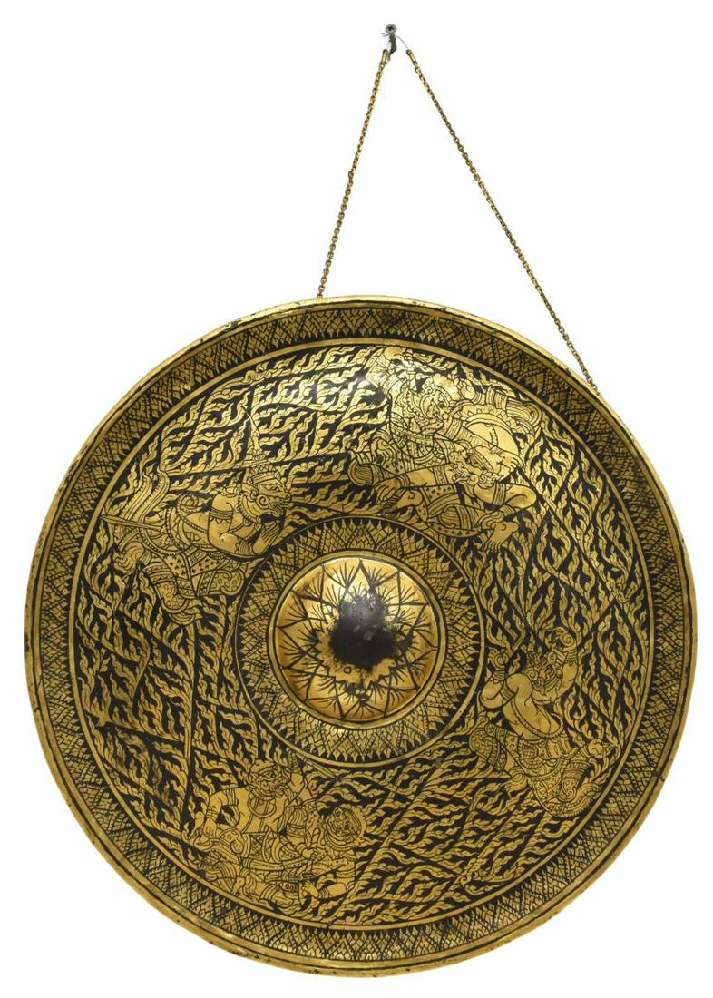 SOUTHEAST ASIAN LACQUERED & GILT METAL TEMPLE GONG: Southeast Asian lacquered and gilt metal temple gong, Thailand, central raised boss, decorated with deities and demons, scrolling flame-like foliage, approx 16.5"diam, 7.25lbs **Provenance: From the e