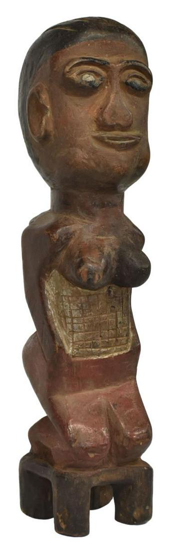 TRIBAL CARVED & POLYCHROMED KNEELING FEMALE FIGURE: Tribal carved female figure, polychrome painted, kneeling on a stool, approx 14.5"h, 3.25"w, 3.5"d, 2.25lbs **Provenance: From the estate of Ali A. Abssi (1934-2020) and Florence Hall Abssi (1919-2014