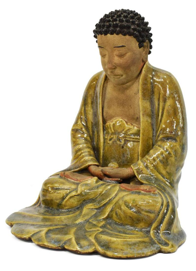 CHINESE SANCAI SEATED MEDITATION BUDDHA: Chinese Sancai glazed Buddha, seated in Dhyana (meditation) Mudra, tightly curled hair, flowing robes, approx 9.25"h, 7.5"w, 7.75"d, 4.25lbs **Provenance: From the estate of Ali A. Abssi (1934-2020) a