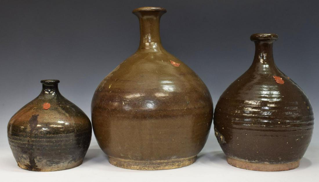 (3) CHINESE EARTHENWARE WINE/ OIL VESSELS: (lot of 3) Chinese earthenware wine/ oil vessels, varied sizes, flared rim, short neck, bulbous body, each retaining partial remnants of wax seal, largest: approx 13"h, 10.5"diam; 18.5lbs total Start 