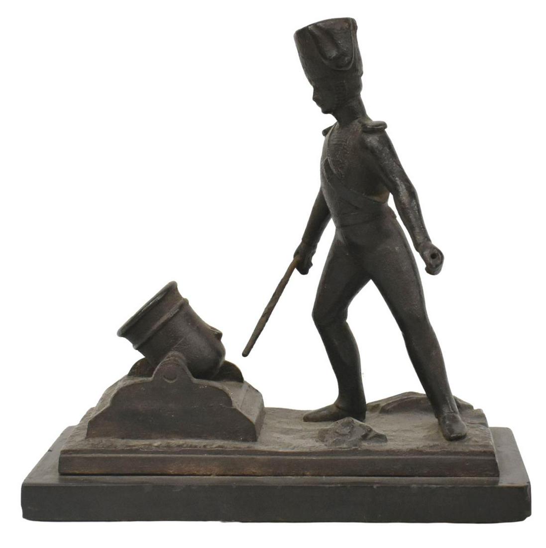 FRENCH CAST IRON HUSSAR SOLDIER & CANNON: French cast iron figure, Hussar soldier with cannon, on black slate base, small chips to edges of base, approx 7"h, 7"w, 3.75"d, 3.25lbs **Provenance: From the estate of Ali A. Abssi (1934-2020) and F