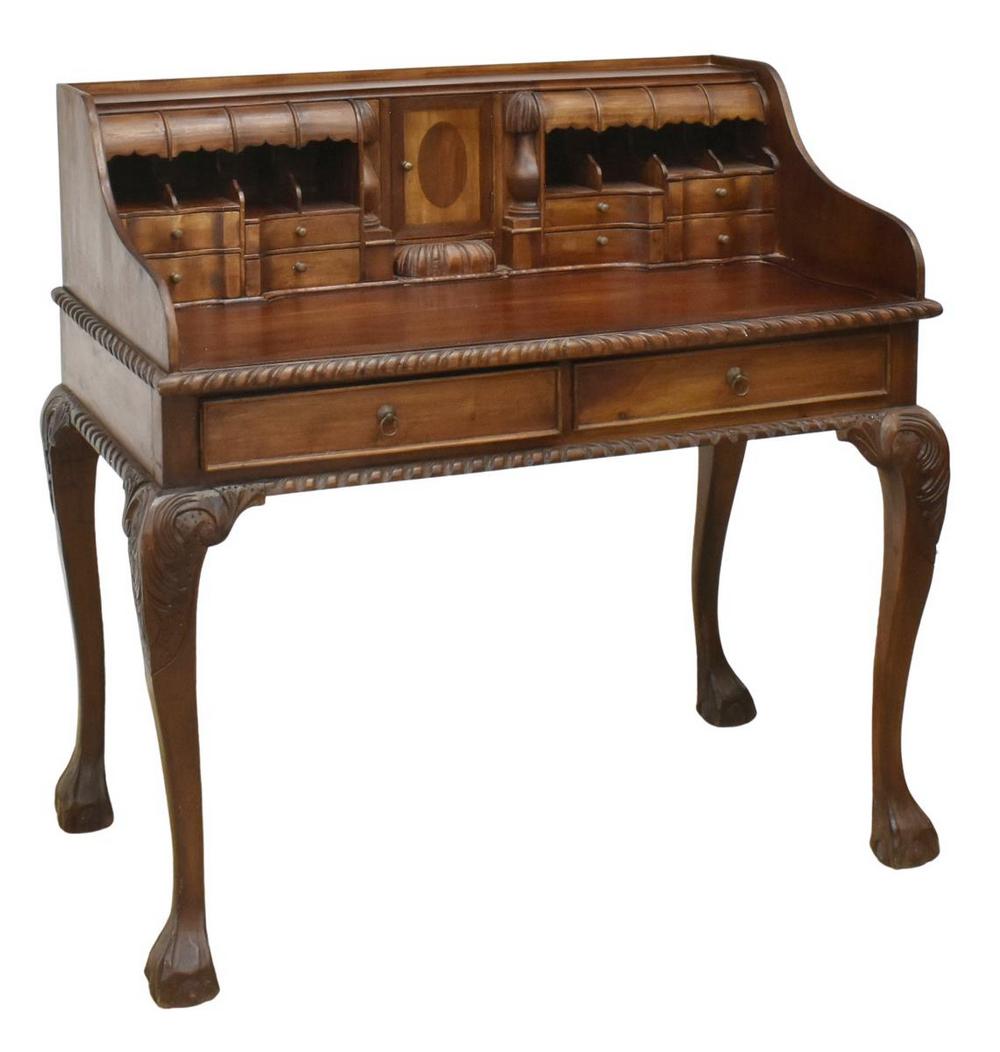 CHIPPENDALE STYLE CARVED MAHOGANY LADIES DESK: Chippendale style mahogany ladies writing desk, 20th c., gallery shelf, above two canopy carved drawers, over center cabinet door and eight drawers, writing surface over two exterior drawers, with car