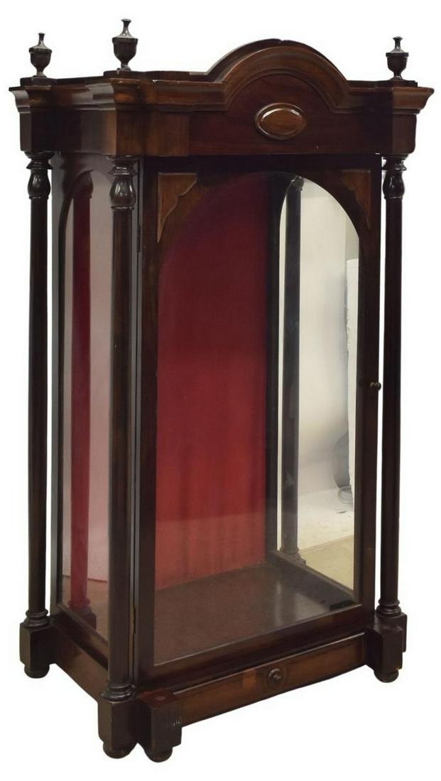 SPANISH ROSEWOOD RELIGIOUS CAPILLA CABINET: Spanish rosewood capilla display cabinet, 19th c., having cornice top with turned finials, over center cartouche, glazed door and side panels, lined interior, flanked by turned columns, over lower dra