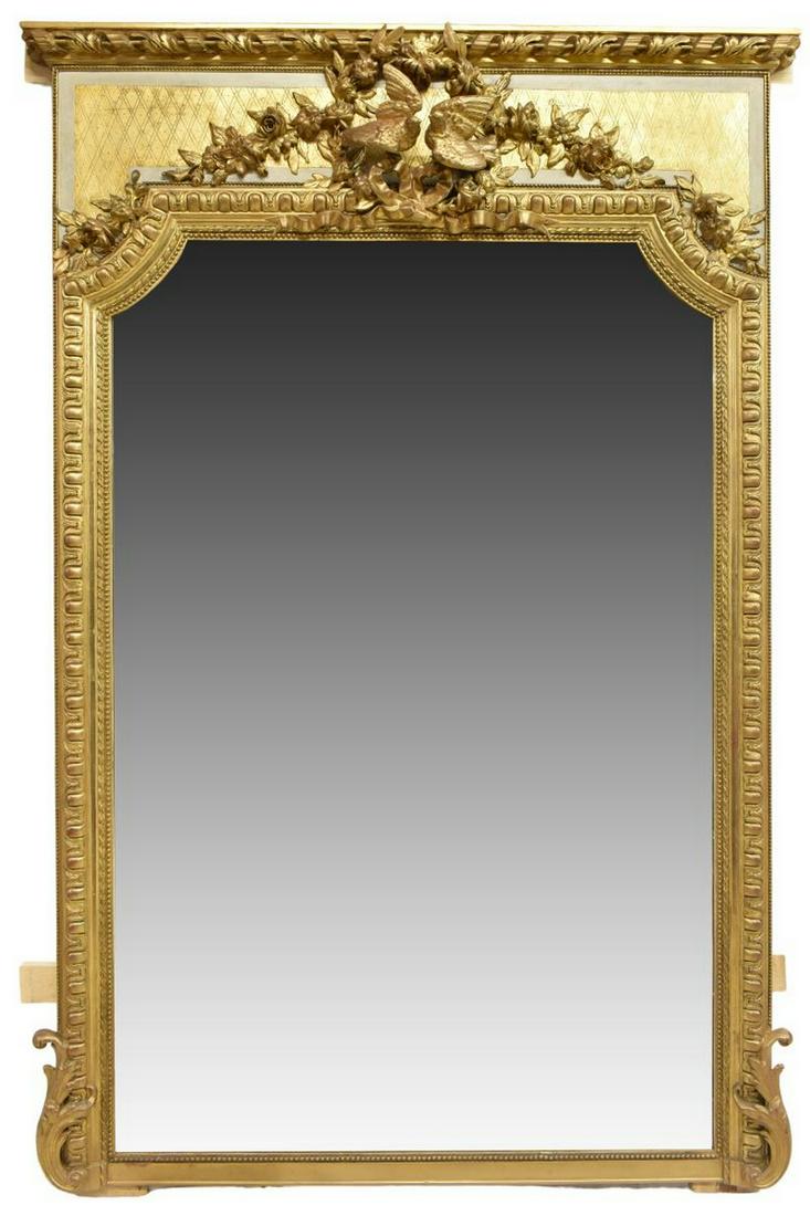 LOUIS XVI STYLE GILTWOOD MIRROR, 87.5" X 57.5": French Louis XVI style giltwood mirror, early 20th c., molding cornice, elaborate floral crest with pair of doves, carved frame with beaded trim, encasing flat mirror plate, approx 87.5"h, 57.5"w, 130