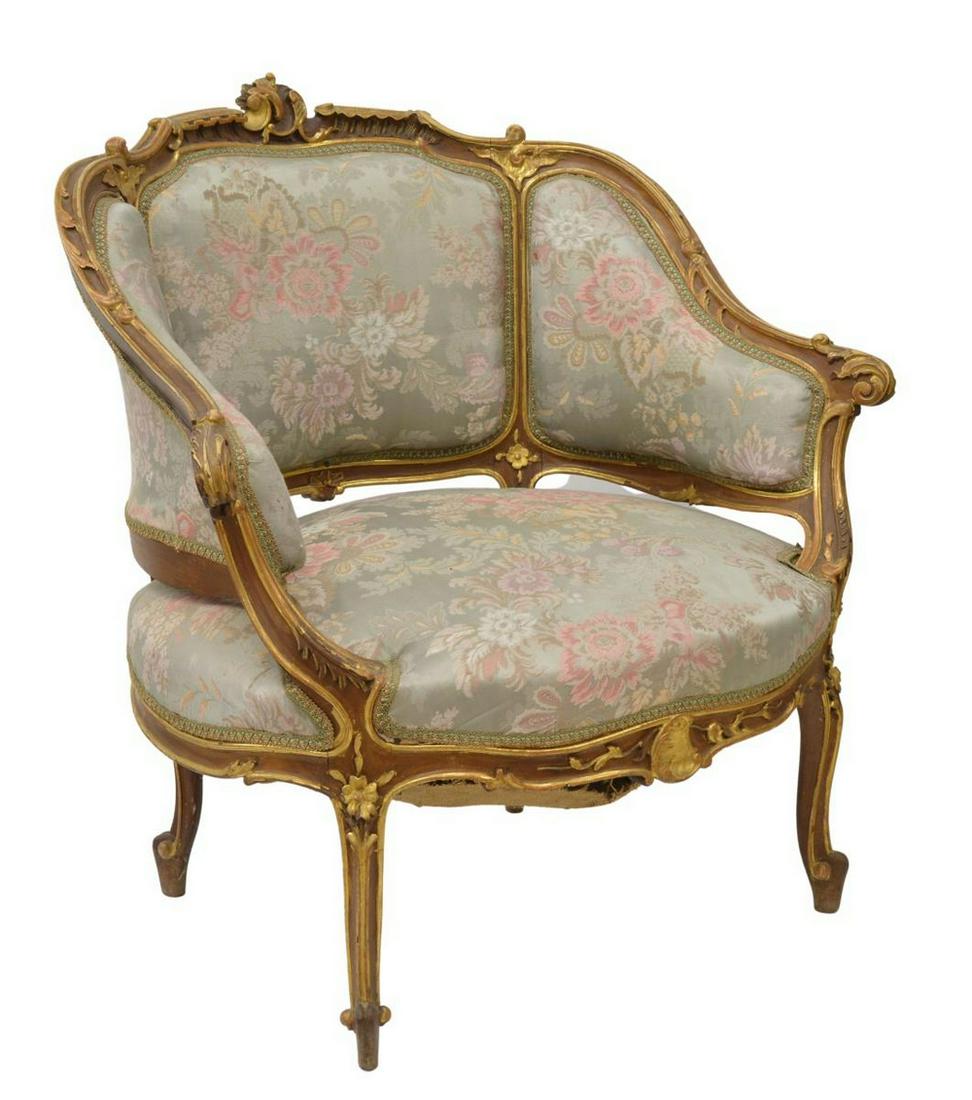 LOUIS XV STYLE UPHOLSTERED PARCEL GILT BERGERE: Louis XV style armchair, late 19th c., parcel gilt frame with foliate scroll handholds, back and seat in floral patterned jacquard upholstery, rising on cabriole legs, ending in whorl feet, approx 31"