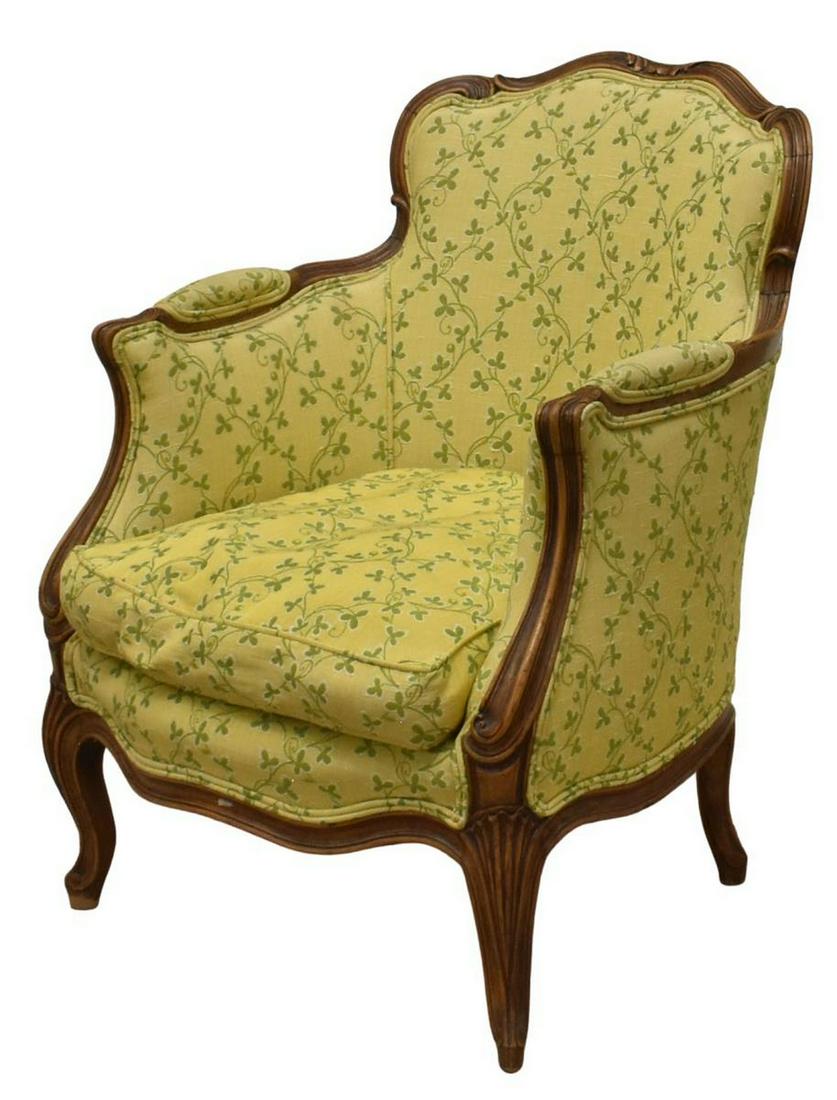 FRENCH LOUIS XV STYLE UPHOLSTERED BERGERE: French Louis XV style armchair, early 20th c., walnut frame, woven upholstery, closed arms, loose seat cushion, rising on cabriole legs, approx 31"h, 24.5"w, 22.5"d, seat height: approx 16"h Start Pri