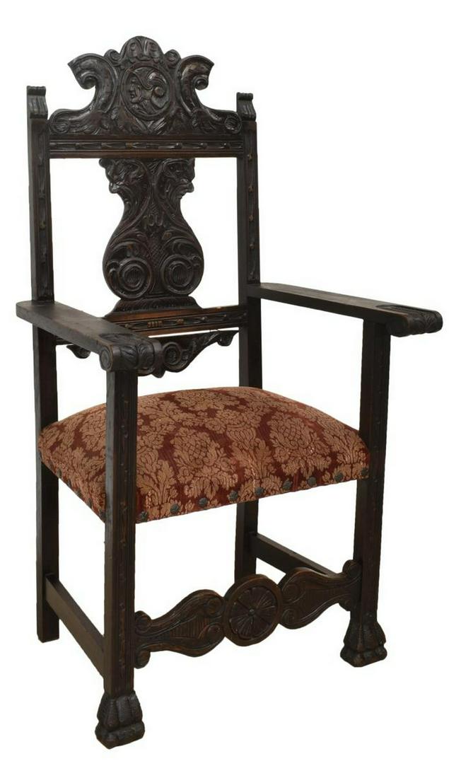 SPANISH RENAISSANCE REVIVAL CARVED ARMCHAIR: Spanish Renaissance Revival armchair, late 19th c., carved crest with portrait medallion of knight in profile, center splat with grotesque masks, wide armrests ending in scrolling foliate handholds, o