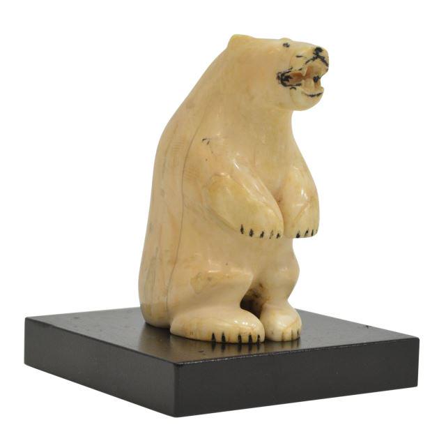 INUIT CARVED WALRUS TUSK POLAR BEAR: Inuit carved walrus tusk, modeled as a polar bear, with black accents, later black wood display stand, bear only: approx 3.75"h, 2.5"w, 1.5"d, 0.5lbs Start Price: $80.00