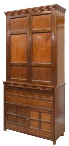 ENGLISH LINEN PRESS FASHIONED AS A RIFLE CABINET: English linen press, now fashioned as a rifle cabinet, molded cornice, paneled double doors opening to interior shelves and fitted rifle storage, pull-out brushing slide with worn inset leather surfac