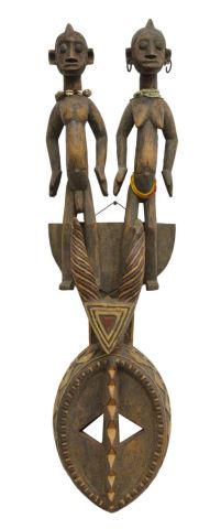 TALL AFRICAN BURKINA FASSO PIGMENTED FIGURAL MASK: African carved wood mask, possibly Mossi People, Burkina Faso, with polychrome pigments, an oval facial plane, divided by a carved nose ridge, under stylized antelope horns, surmounted by male and fem