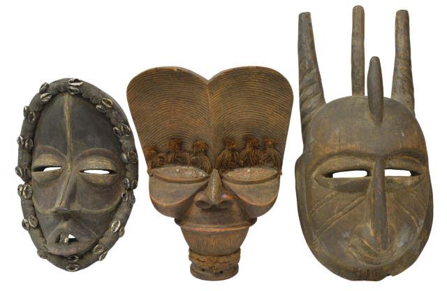 (3) WEST AFRICAN FIGURAL CARVED MASKS & CREST: (lot of 3) African figural carvings, including: (1) Dan mask, Liberia, having well-defined face, in a cowrie shell accented surround, approx 15"l, 6"w, 5.75"d; (1) large wood mask with well-defined fe