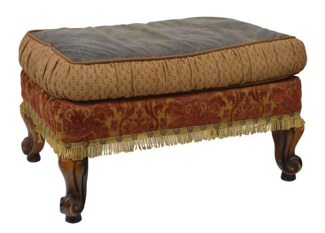 JEFF ZIMMERMAN COLLECTION UPHOLSTERED OTTOMAN: Jeff Zimmerman Collection "Jadyn" upholstered ottoman, late 20th c., cushion seat with leather top, fringe skirt, rising on cabriole legs, ending in whorl feet, approx 17.5"h, 30"w, 21"d Start Price: