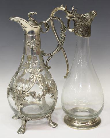 (2) PEWTER-MOUNTED COLORLESS GLASS CLARET EWERS: (lot of 2) Continental mounted glass claret jugs, marked underfoot, including: (1) Vagabond House colorless glass claret wine pitcher, having curved handle and stag head lid, approx 12.25"h, 4.5"diam,