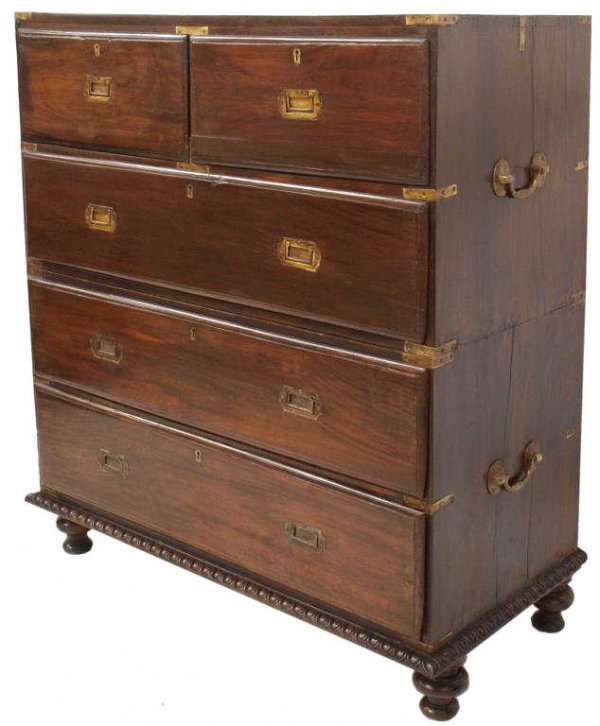 COLONIAL BRASS BOUND ROSEWOOD CAMPAIGN CHEST: British Colonial brass bound rosewood campaign chest in two-parts, 19th c., the upper case having two small drawers over a long drawer, the lower enclosing two long drawers on a base with egg-and-dart