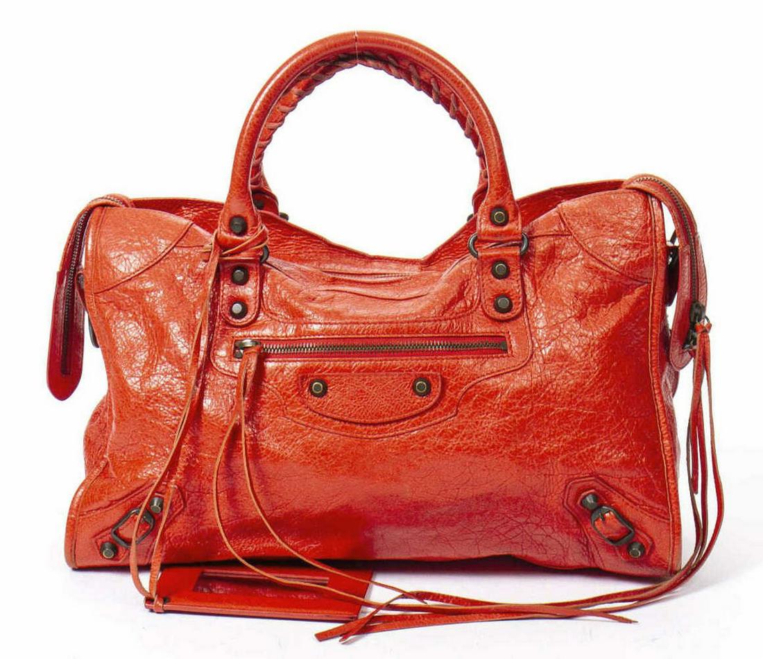BALENCIAGA MOTORCROSS CLASSIC CITY SHOULDER BAG: Balenciaga "Motorcross City" handbag, in red distressed leather, with antiqued brass hardware, dual rolled top handles with whipstitch detail, single exterior zip pocket at front face, stud and buckle