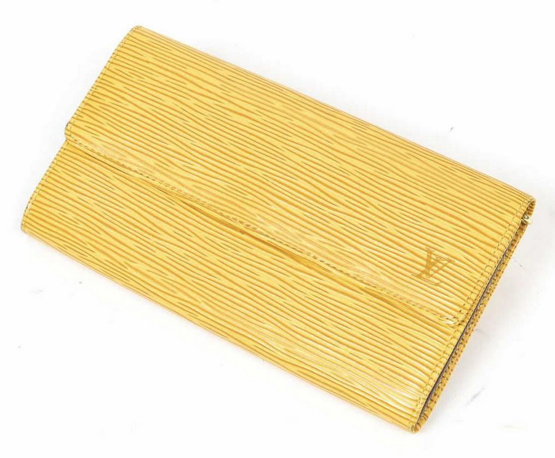LOUIS VUITTON 'PORTE-MONNAIE CREDIT' EPI WALLET: Louis Vuitton "Porte-Monnaie Credit" wallet, in yellow Epi leather, with brass hardware, purple Taiga leather lining, three interior compartments, center with zip closure, snap closure at front flap,