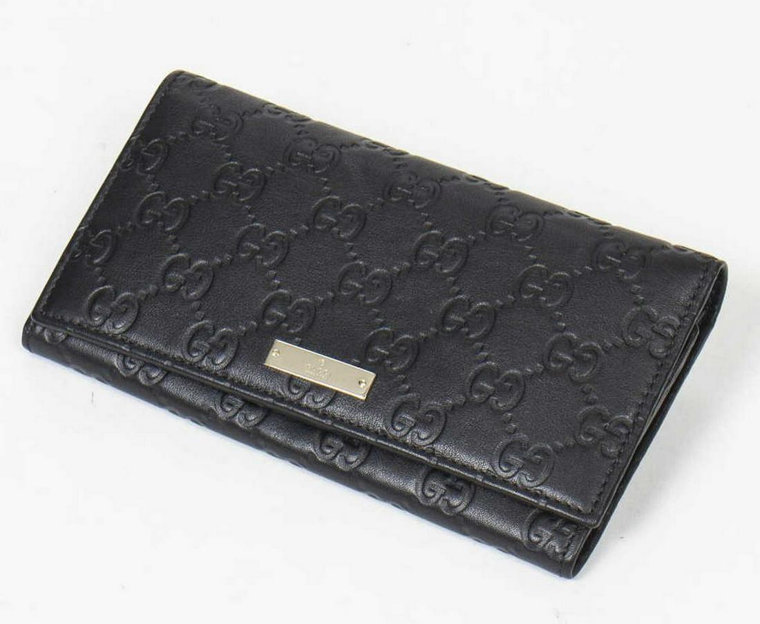 GUCCI BLACK GUCCISSIMA LEAETHER CONTINENTAL WALLET: Gucci continental wallet, in black Guccissima leather, with gold-tone hardware, tonal leather lining, bill compartments, five card slots, snap closure at front flap, wallet: measurements for shipping