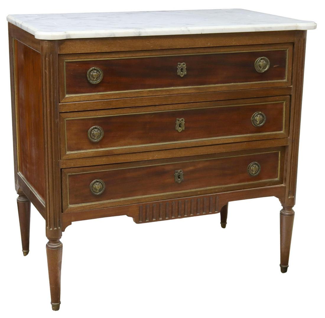 FRENCH LOUIS XVI STYLE MARBLE-TOP MAHOGANY COMMODE: French Louis XVI style marble-top mahogany commode, early 20th c., shaped marble-top, over rectangular case fitted with three drawers, having brass trim, ribbon escutcheons, urn motif ring pulls, flan