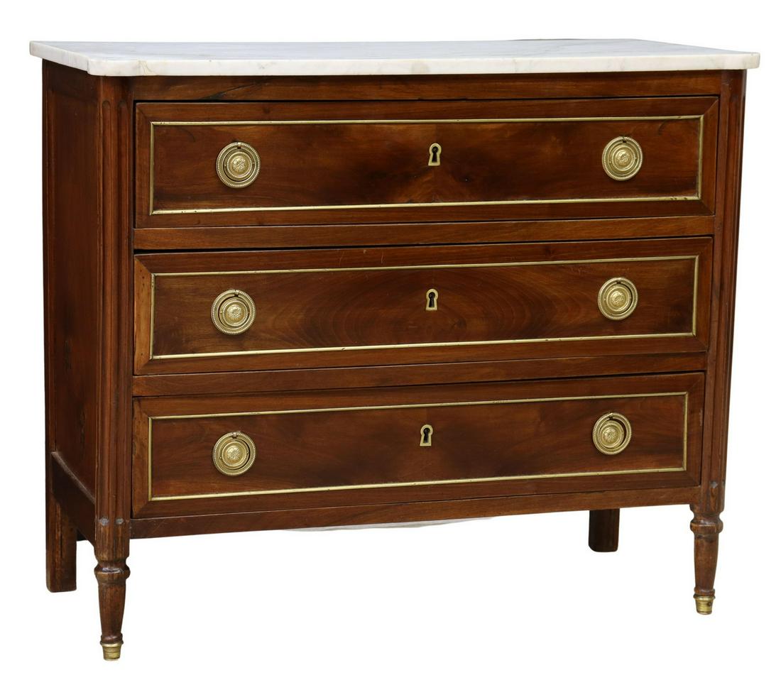 FRENCH LOUIS XVI STYLE MARBLE-TOP MAHOGANY COMMODE: French Louis XVI style marble-top mahogany commode, late 19th c., fitted with three drawers, flanked by fluted corner posts, rising on tapered legs, ending in metal-capped feet, restoration to marble