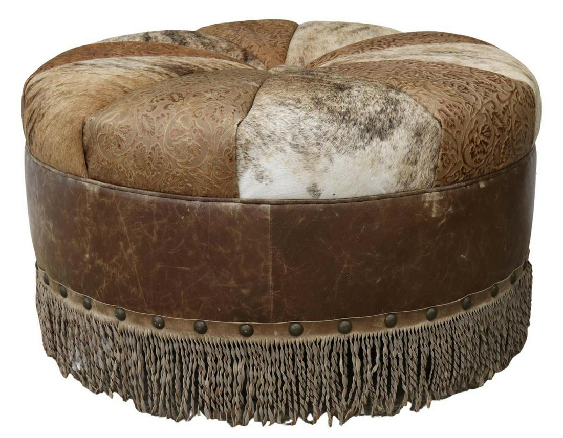 LARGE WESTERN COWHIDE & LEATHER OTTOMAN: Large contemporary western cowhide and leather ottoman, Old Hickory Tannery, late 20th c., circular shape, segmented top with cowhide and tooled leather, nailhead trim, twisted leather fringe, on turn