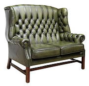 CHIPPENDALE STYLE BUTTONED GREEN LEATHER LOVESEAT: English Chippendale style wingback loveseat, late 20th c., in green leather upholstery, button-tufted back and rolled arms, brass tack trim, two loose seat cushions, rising on mahogany Marlborough leg