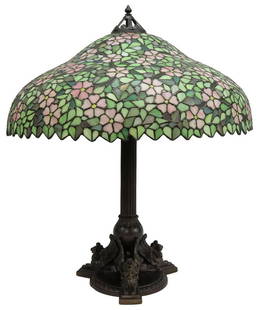 HANDEL APPLE BLOSSOM STAINED & LEADED GLASS LAMP: American stained and leaded glass table lamp, Handel Lamp Company, c.1900, domed glass shade with pink apple blossoms against a green foliated ground, concealing three lights, patinated metal base wit