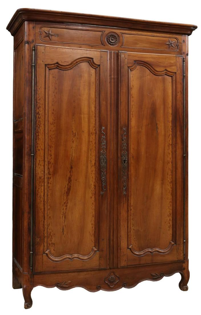 FRENCH PROVINCIAL LOUIS XV STYLE TWO-DOOR ARMOIRE: French Provincial Louis XV style armoire, late 18th/ early 19th c., molded cornice, frieze with floral roundel, five-pointed stars, two paneled doors on long exterior hinges, scalloped apron, rising o