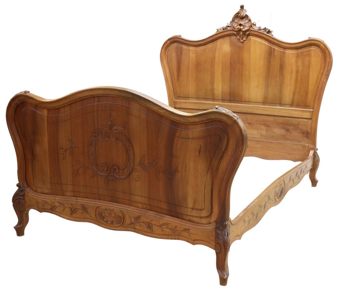 LOUIS XV STYLE CARVED WALNUT BED: Louis XV style walnut bed, early 20th c., shaped headboard with carved rocaille crest, matching rails and footboard, rails accented with incised vining foliates, rising on cabriole legs with acanthus-