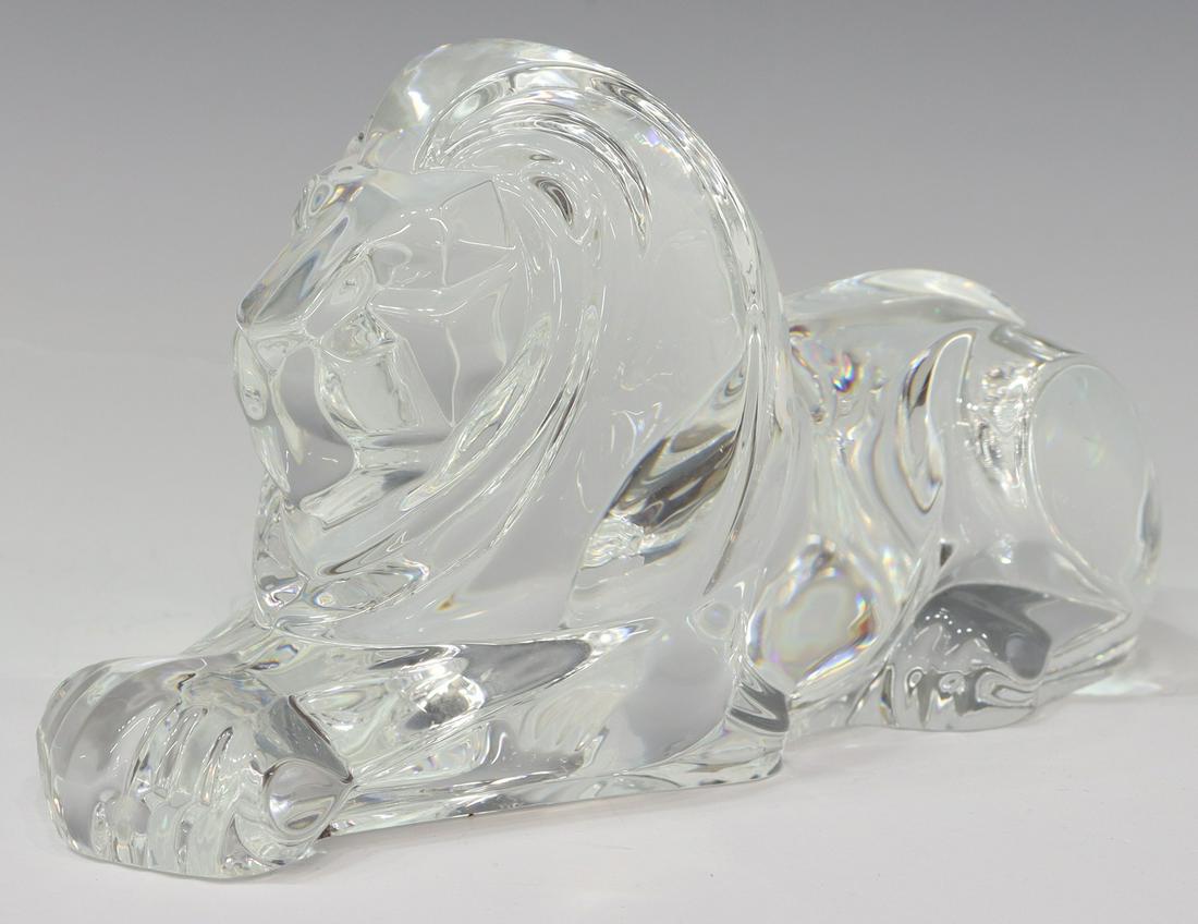 STEUBEN LLOYD ATKINS GLASS REPOSING LION FIGURE: Steuben colorless leaded art glass figure, Reposing Lion, designed by Lloyd D. Atkins (American, b.1922), engraved signature underfoot, approx 4.25"h, 8"l, 3 1/8"d, 4.75lbs **Provenance: A fine Santa