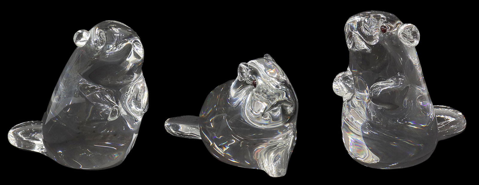 (3) STEUBEN LLOYD ATKINS GLASS BEAVER FIGURES: (lot of 3) Steuben colorless leaded art glass figures, Beavers, designed by Lloyd Atkins (American, b.1922), with inset garnet eyes, engraved signature underfoot, (1) approx 3"h, (2) approx 3.75"h, (o