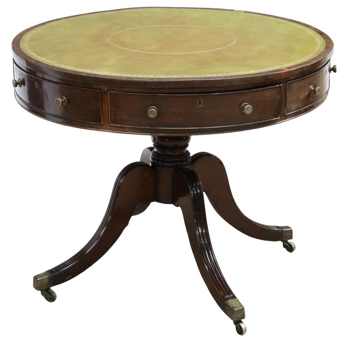 ENGLISH REGENCY LEATHER-TOP MAHOGANY RENT TABLE: English Regency period mahogany drum-top/ rent table, early 19th c., inset gilt embossed leather top, over six drawers, bulbous turned center pedestal, four downward scrolled legs, brass-capped feet, 
