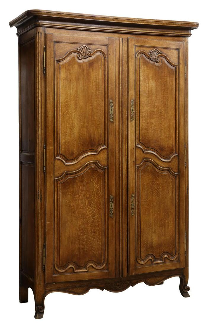 LARGE FRENCH PROVINCIAL LOUIS XV STYLE OAK ARMOIRE: French Provincial Louis XV style oak armoire, 19th c., molded cornice, over paneled doors on exterior hinges, interior shelves, scalloped apron, raised on scrolled feet, approx 95"h, 62.5"w, 24"d **Pr