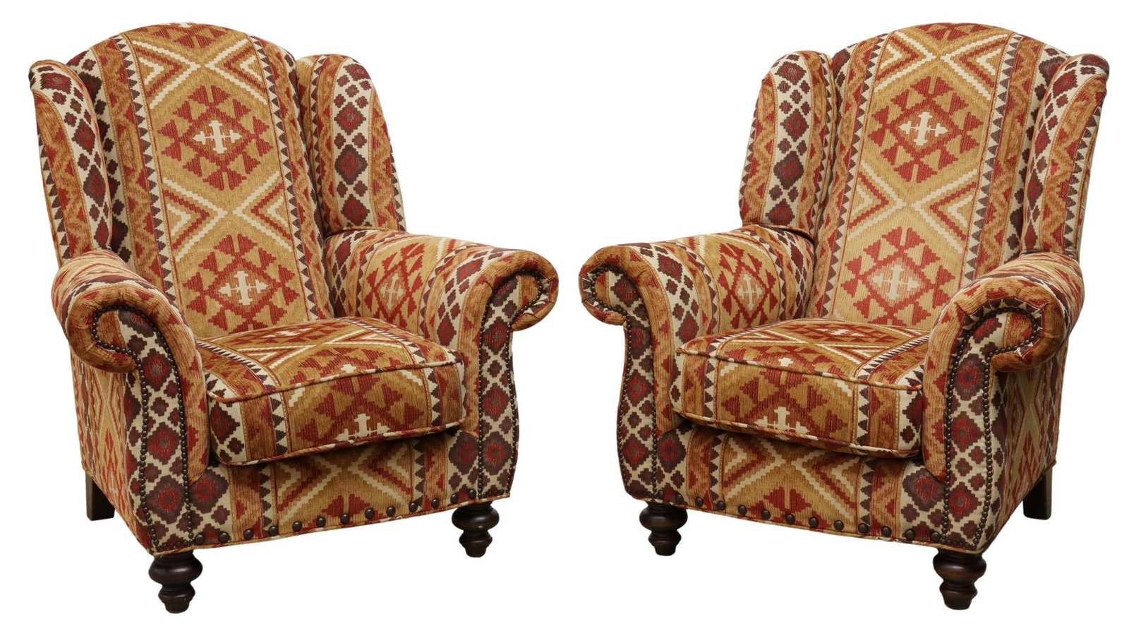 (2) SOUTHWEST STYLE UPHOLSTERED WINGBACK ARMCHAIRS: (pair) Southwest style wingback armchairs, Furniture Your Way Inc., late 20th c., in kilim-inspired upholstery, padded back framed by small wings, rolled arms with brass tack trim, loose seat cushion,