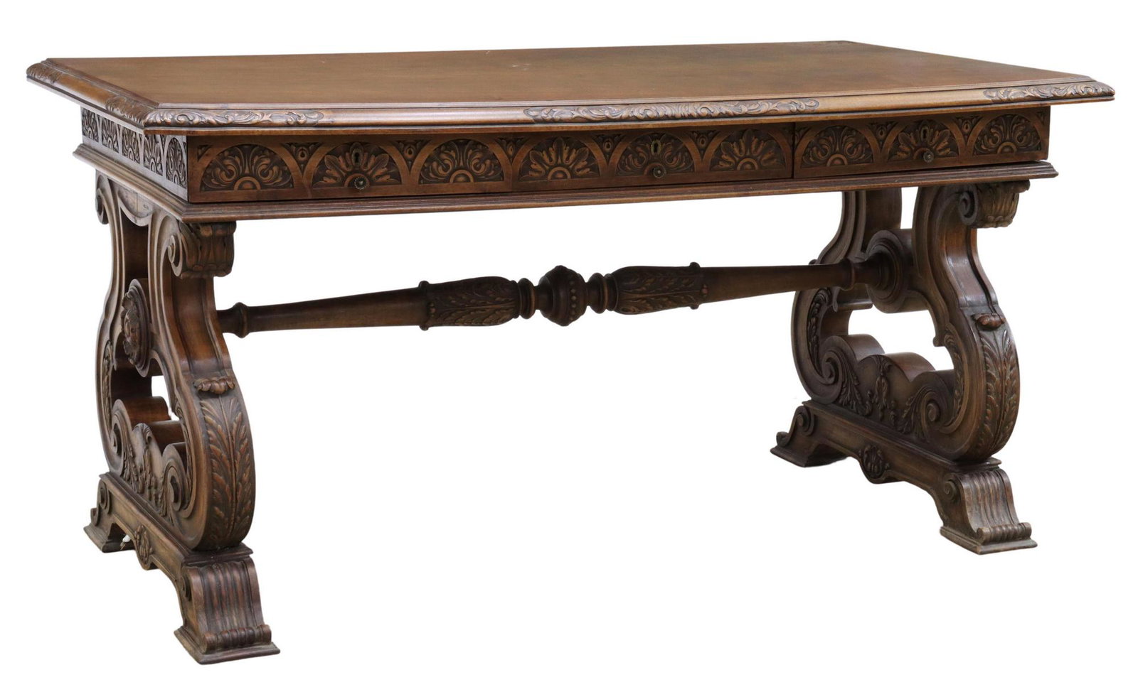 RENAISSANCE REVIVAL WALNUT LIBRARY TABLE DESK: Renaissance Revival walnut library table, late 19th c., rectangular top with carved edge, lunette design at apron, three frieze drawers, rising on acanthus scroll supports, joined by turned cross stre