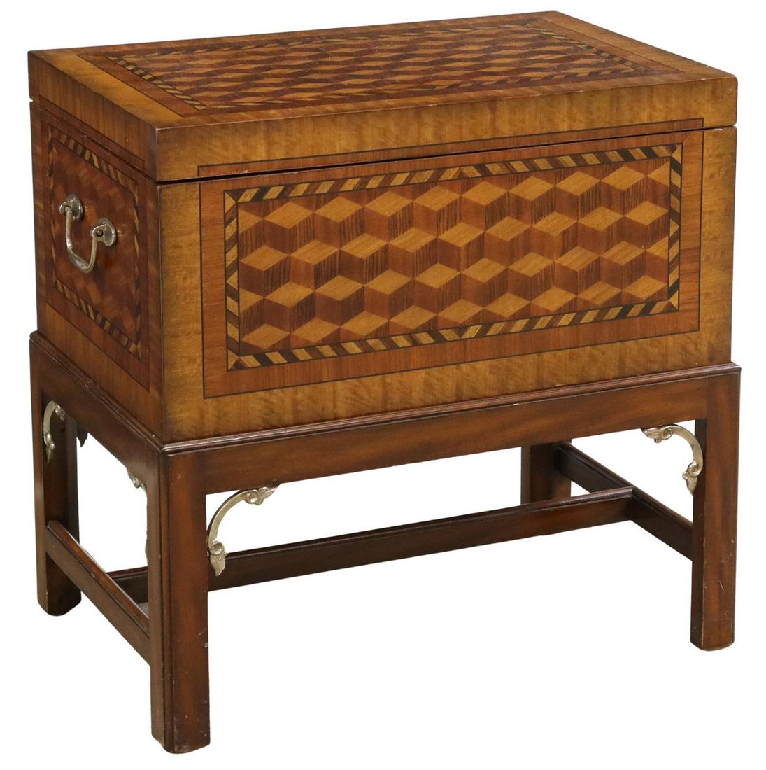 MAITLAND-SMITH MAHOGANY PARQUETRY CHEST ON STAND: Maitland-Smith mahogany chest on integral stand, late 20th c., the top and sides with geometric inlay, a hinged top opening to storage, rising on the open base with squared legs, approx 24.25"h, 24.5"