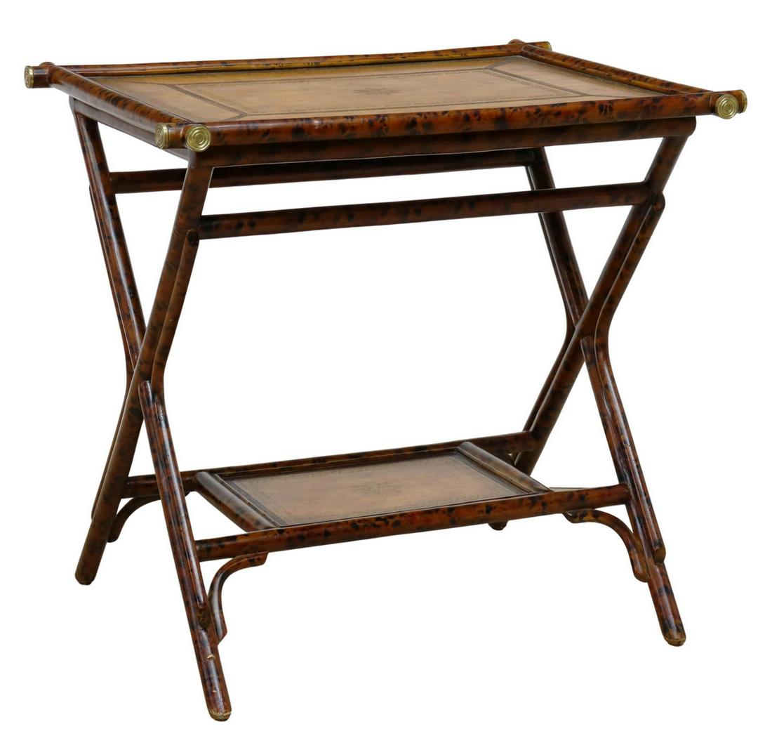 MAITLAND-SMITH FAUX BAMBOO & LEATHER SERVICE TABLE: Maitland-Smith faux bamboo framed serving table, late 20th c., having two gilt-accented, leather-top shelves, x-form frame, approx 24"h, 25.25"w, 19"d **Provenance: A fine Santa Fe, New Mexico estate