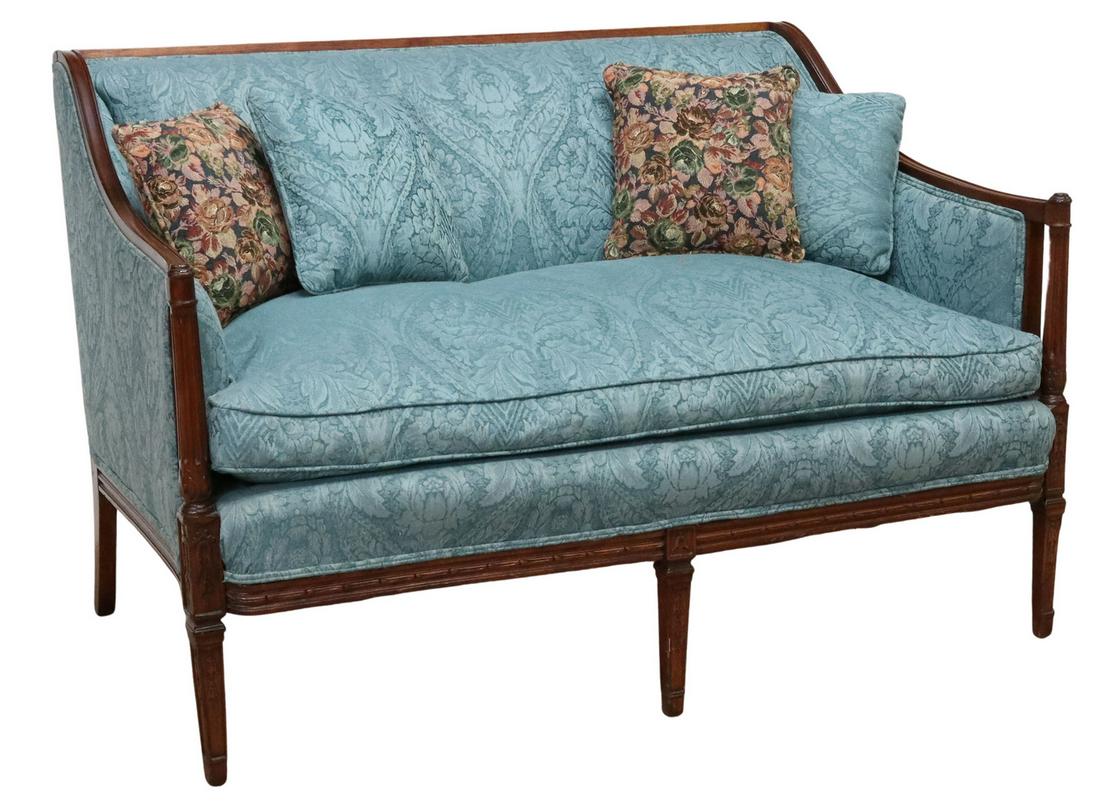 SHERATON STYLE CARVED MAHOGANY FRAME SETTEE: Sheraton style settee, first half 20th c., carved mahogany frame, woven damask patterned upholstery, loose down-filled bench seat cushion, hand-tied springs, fluted column posts, rising on front taper