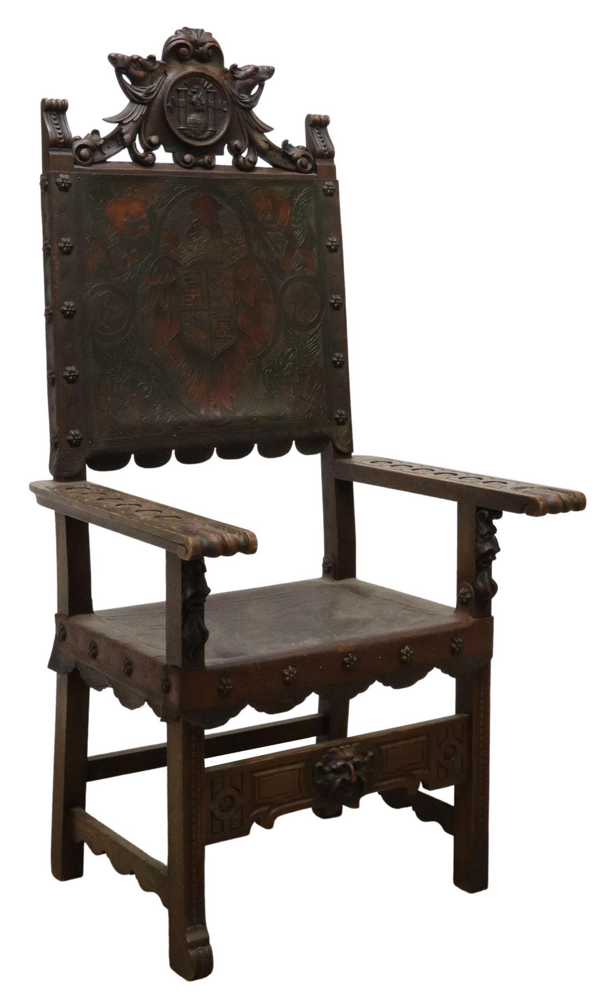 SPANISH BAROQUE STYLE HERALDIC THRONE CHAIR: Spanish Baroque style oak armchair, 19th c., carved crest of eagle perched on globe, wide armrests terminating in scroll handholds, embossed leather back with winged cherubs, heraldic sheild of towers