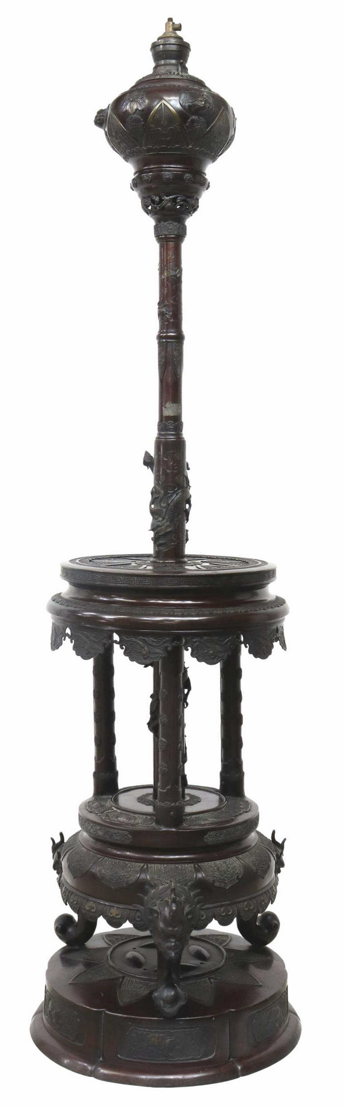 JAPANESE MEIJI BRONZE DRAGON KEROSENE FLOOR LAMP: Japanese Meiji period bronze kerosene oil floor lamp, c.1868-1912, relief decorated throughout with dragons and other mystical beasts, font seated atop tall standard, rising through two round medial l
