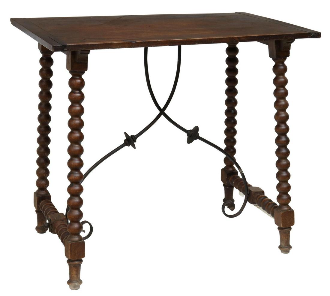 SPANISH BAROQUE STYLE TABLE ON BOBBIN LEGS: Spanish Baroque style mixed wood table, early 20th c., three-board top with side trim, rising on bobbin turned legs, joined by side stretchers, wrought iron center stretchers, ending in turned feet, a
