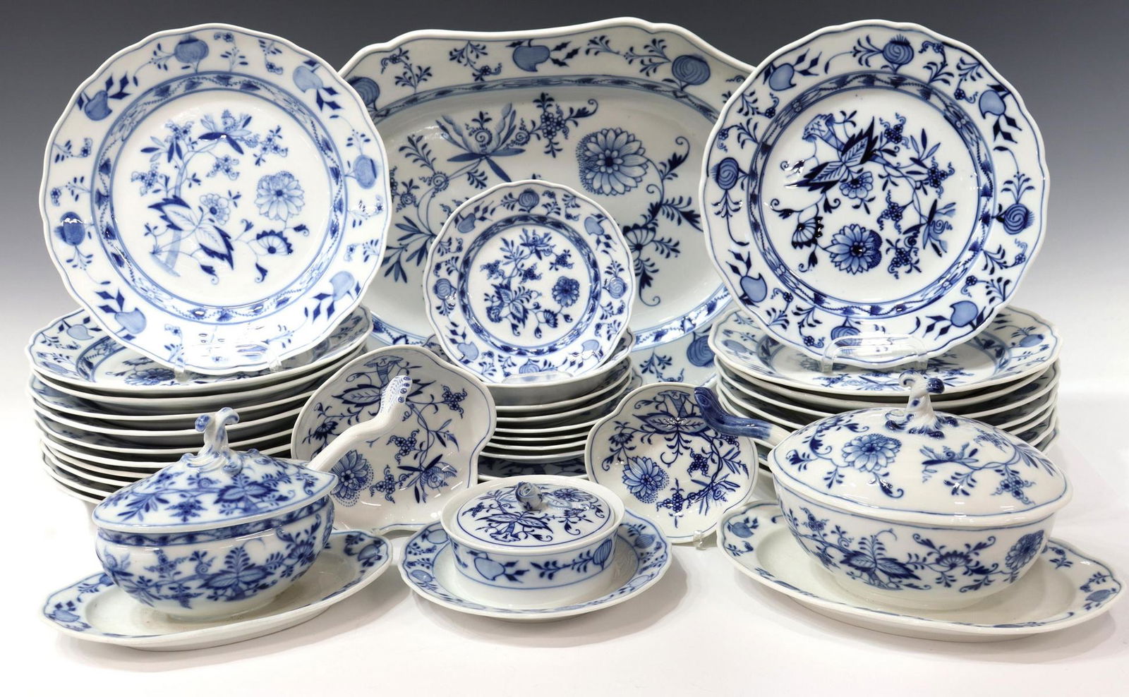 (38) MEISSEN 'BLUE ONION' PORCELAIN DINNER SERVICE: (lot of 38) Meissen "Blue Onion" porcelain dinner service, an assembled collection with various marks including scored seconds and variations of blue underglaze crossed swords, comprising: (20) dinner