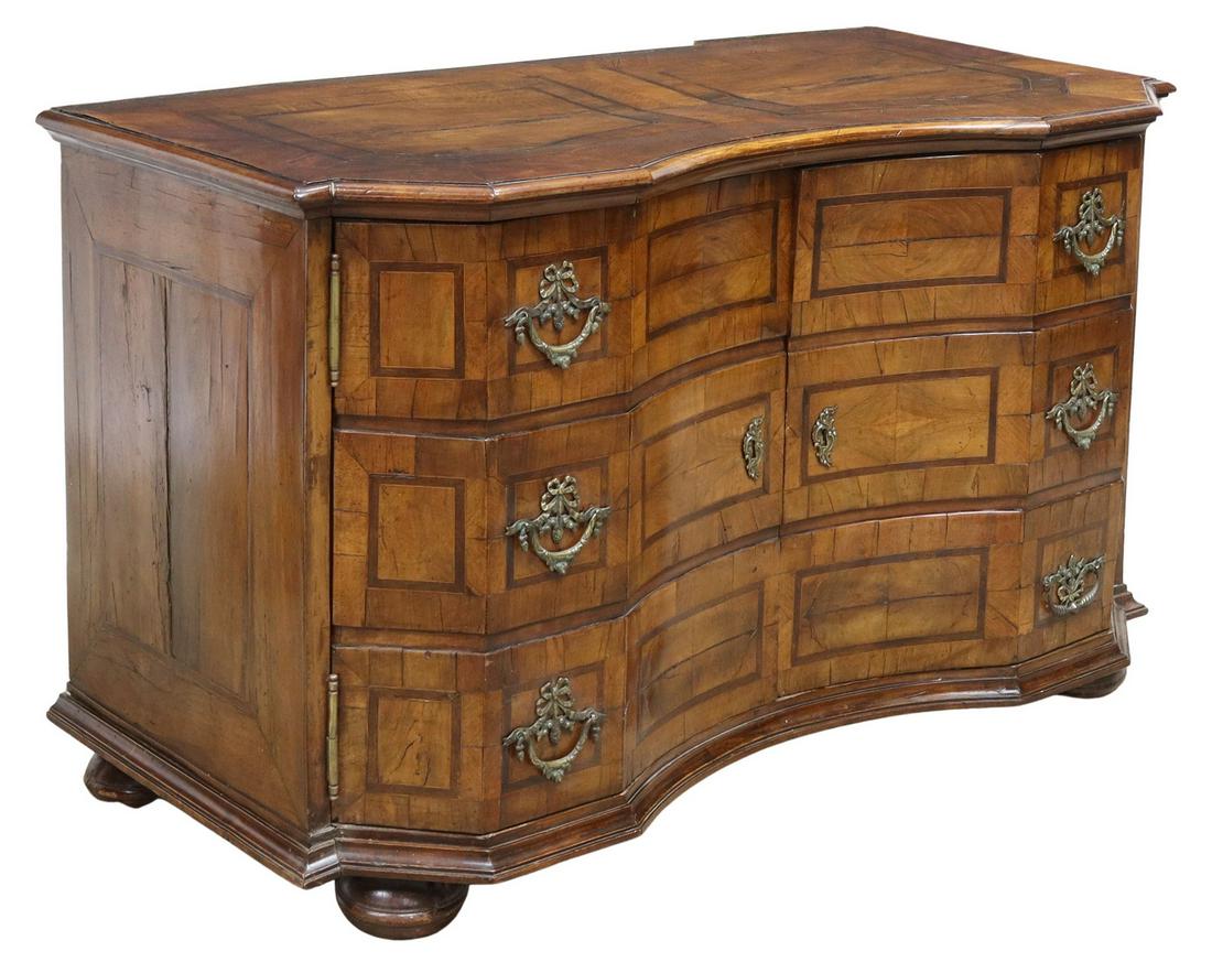ANTIQUE GERMAN INLAID WALNUT COMMODE, 18TH C.: Antique German walnut commode, 18th c., shaped case with concave front, inlaid with contrasting woods, two cabinet doors appearing as three faux drawer fronts, interior shelves, rising on large bun fe