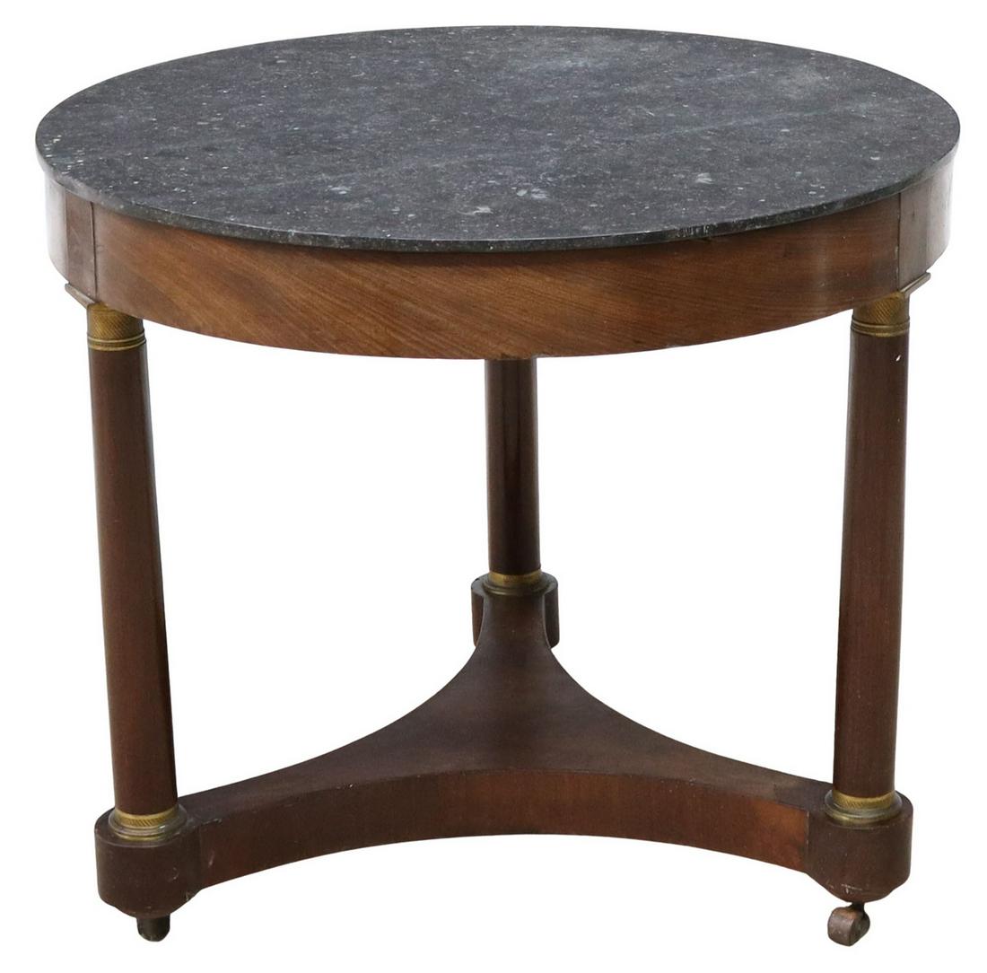 FRENCH EMPIRE STYLE MARBLE-TOP MAHOGANY GUERIDON: French Empire style marble-top mahogany pedestal table, mid 19th c., circular marble top over conforming apron, rising on three column supports with gilt metal accents, joined by shaped platform base,